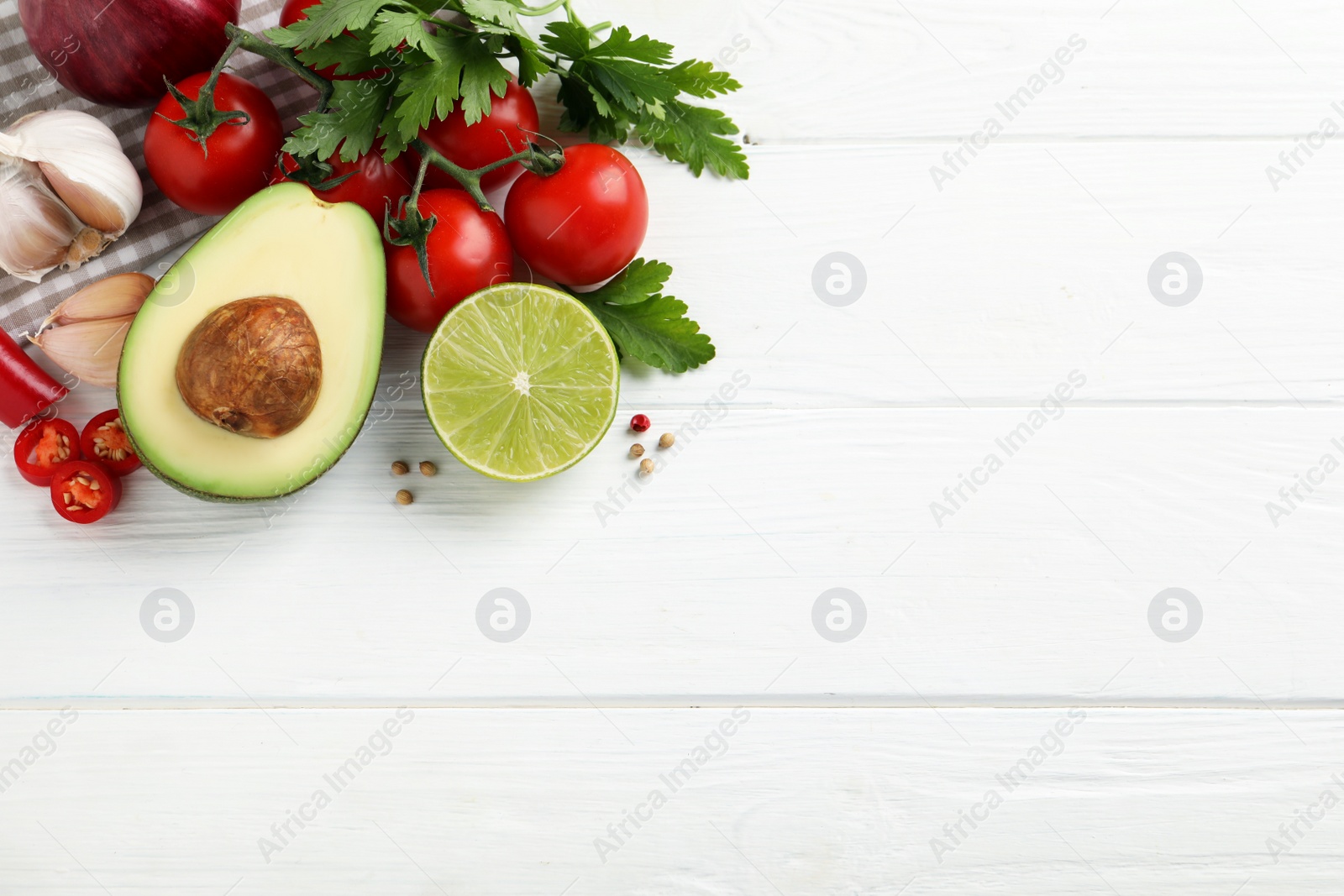 Photo of Fresh guacamole ingredients on white wooden table, flat lay. Space for text
