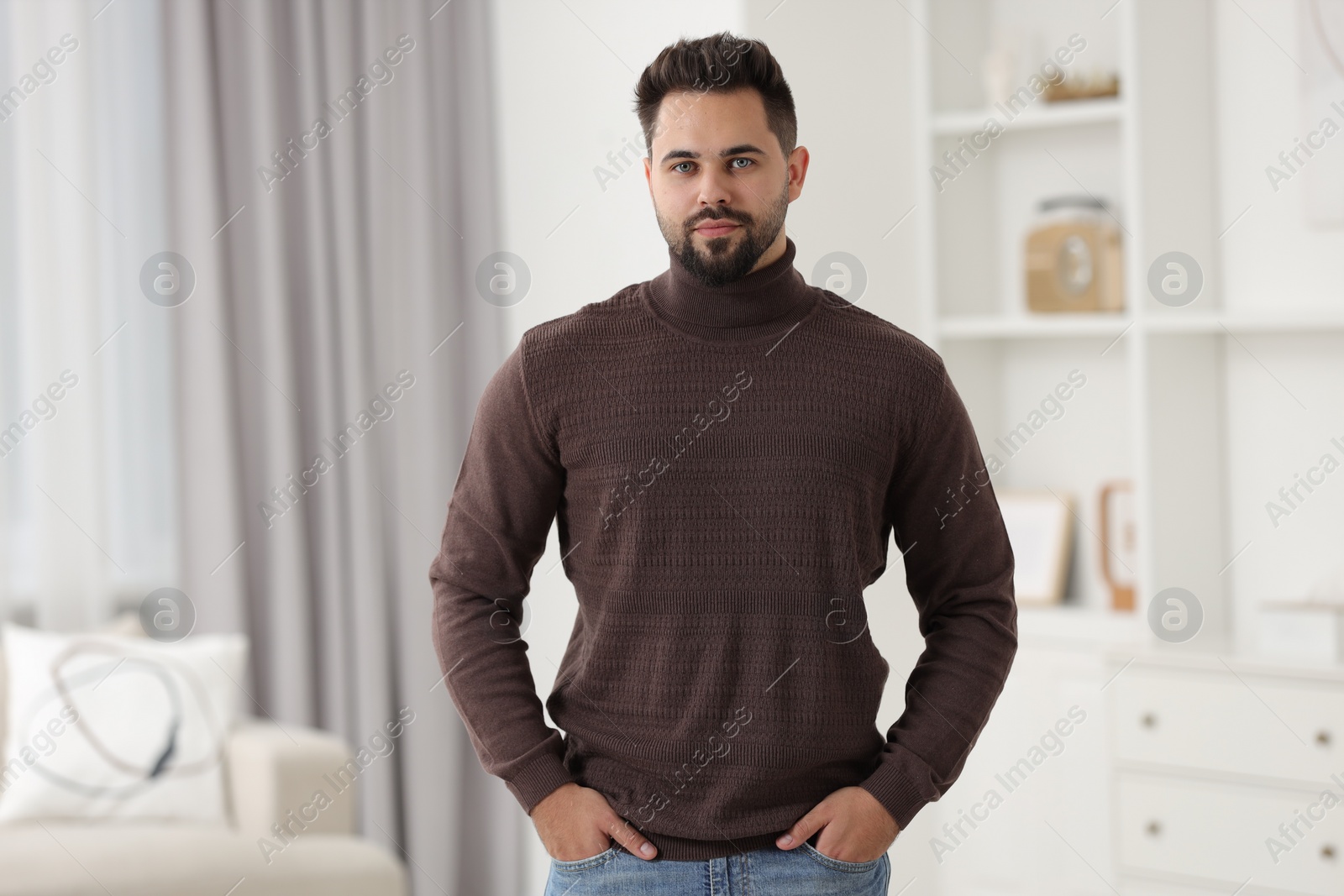 Photo of Handsome man in stylish sweater at home