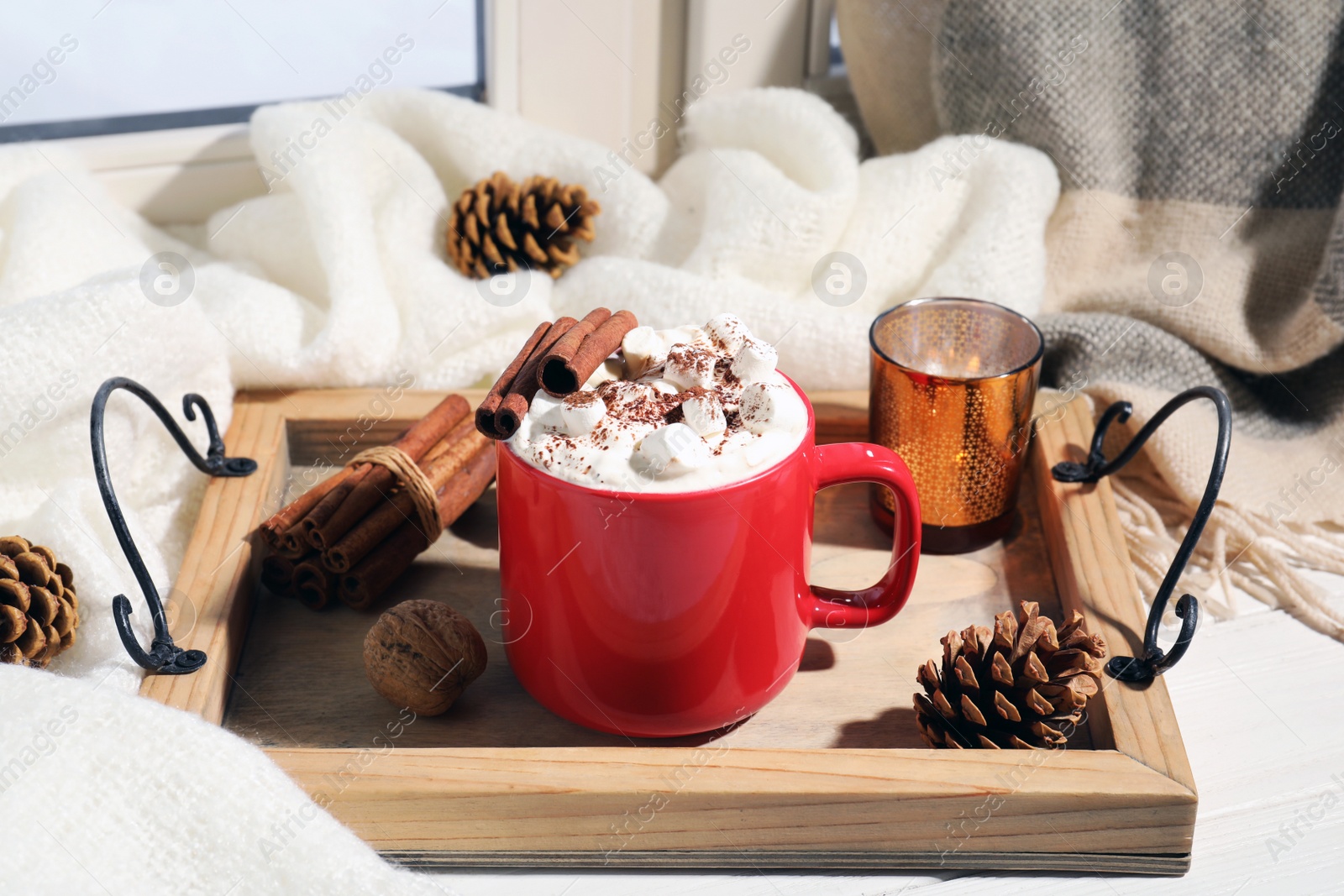 Photo of Tray with cup of cocoa on windowsill. Winter drink