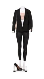 Photo of Female mannequin dressed in black suit and crop top with accessories isolated on white. Stylish outfit
