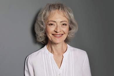 Photo of Portrait of mature woman on grey background