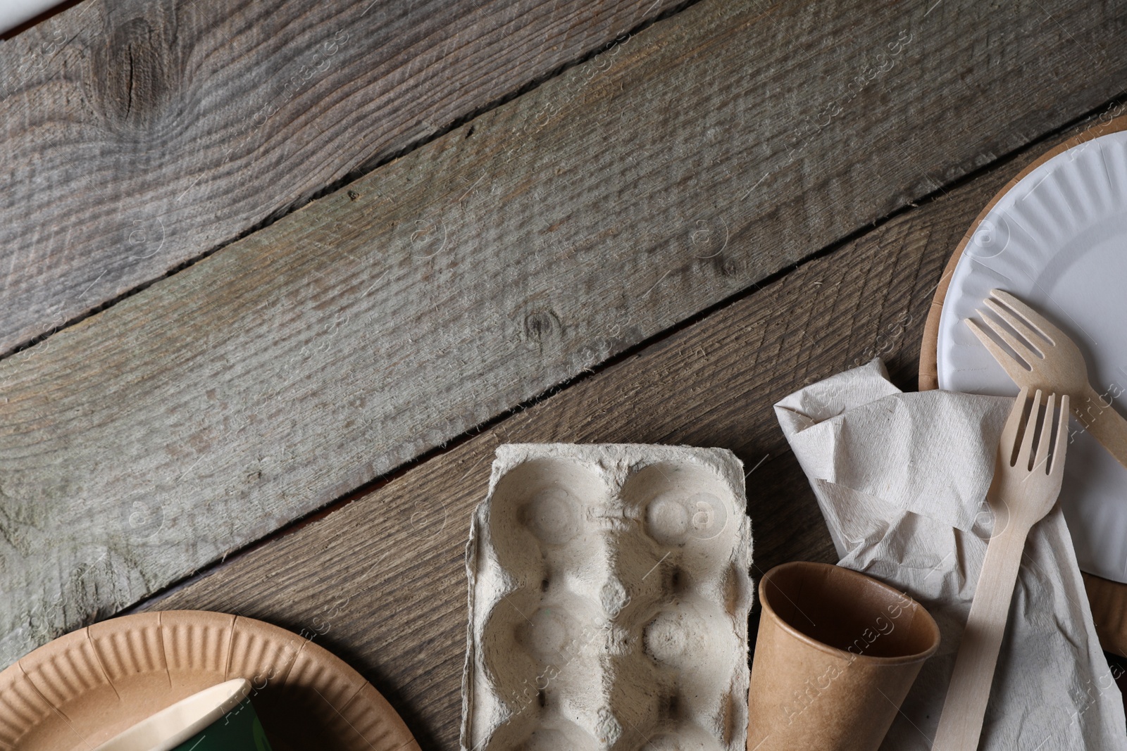 Photo of Waste paper on wooden table, flat lay. Space for text