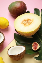 Photo of Juicy melon and other fruits on color background