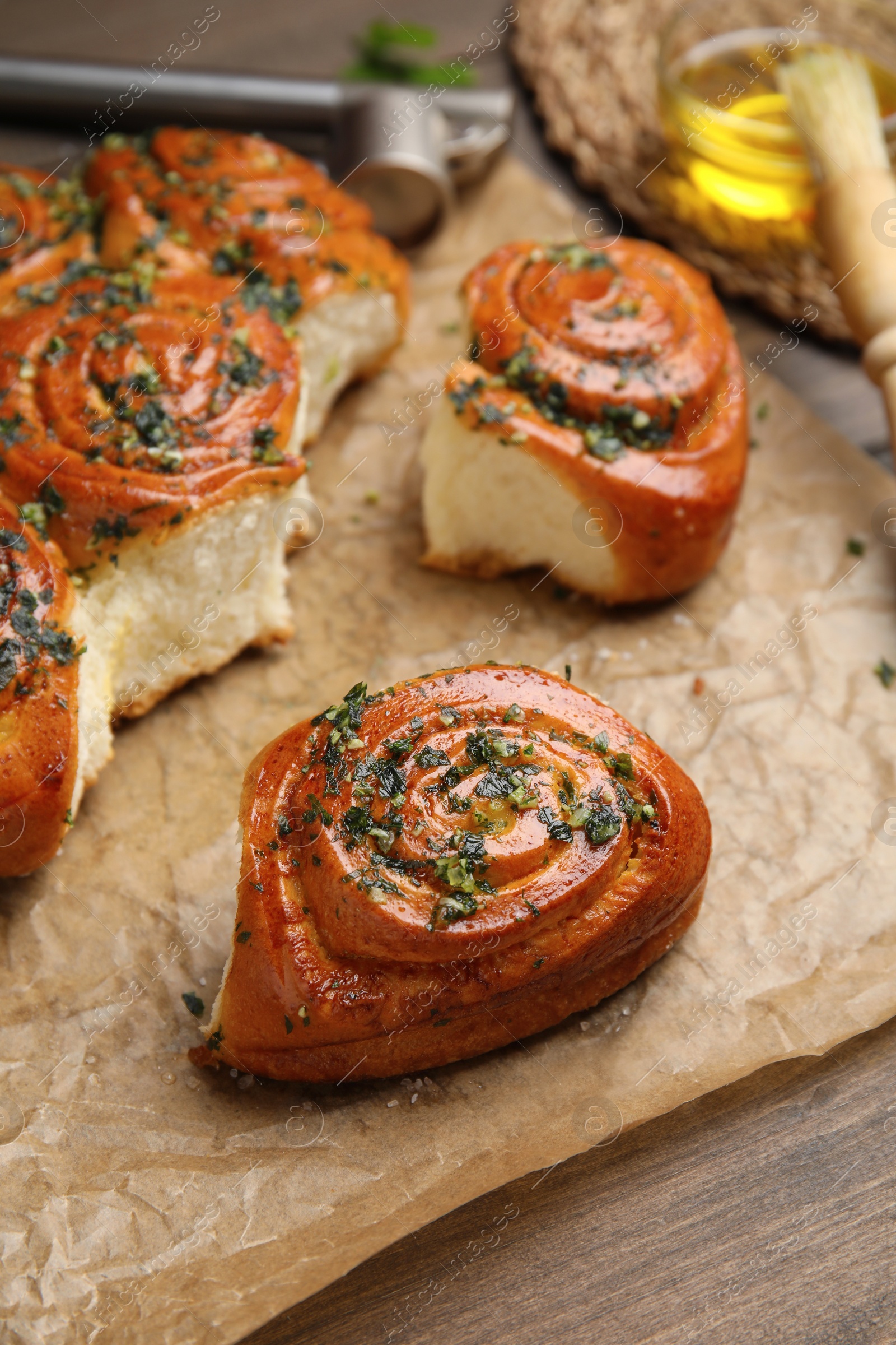 Photo of Traditional Ukrainian bread (Pampushky) with garlic on wooden table