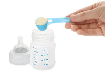 Photo of Woman preparing infant formula on white background, closeup. Baby milk