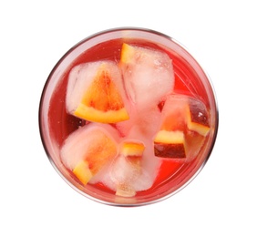 Glass of tropical cocktail with ice cubes on white background, top view