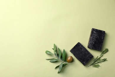 Photo of Flat lay composition with handmade soap bars and space for text on color background