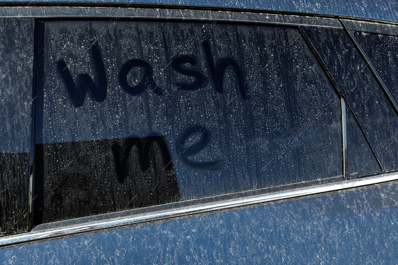 Photo of Inscription Wash me on dirty car window, closeup