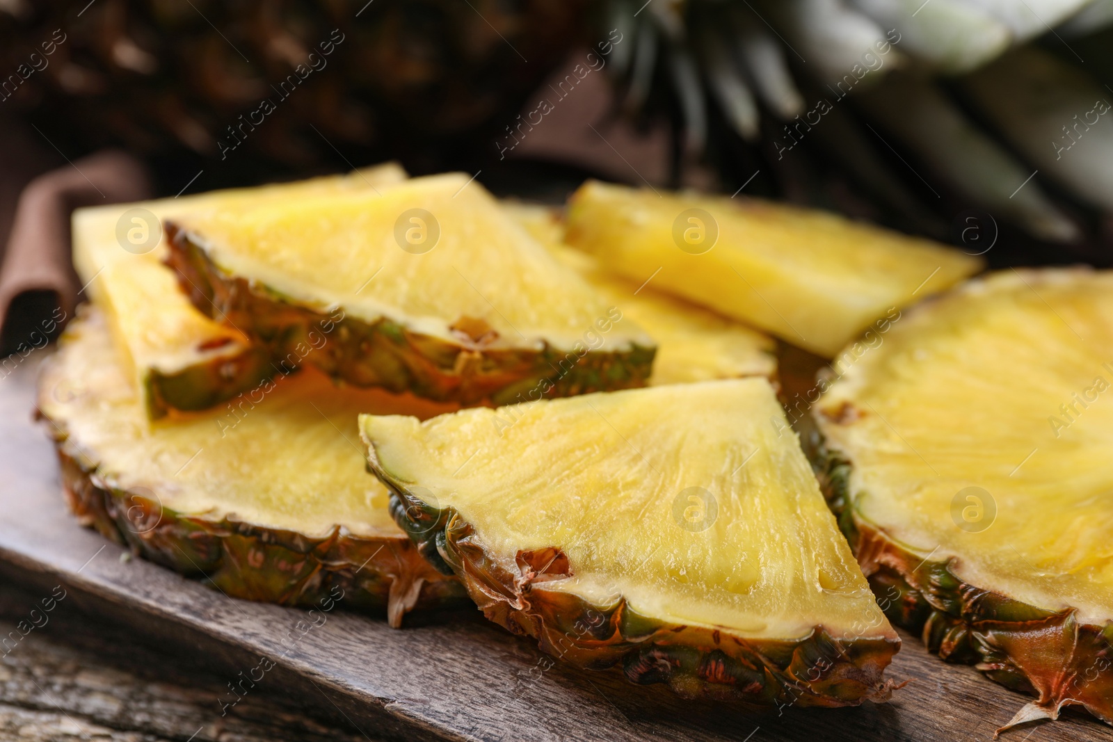 Photo of Pieces of tasty ripe pineapple on table, closeup