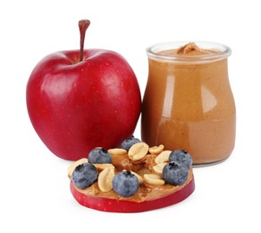 Slice of fresh apple with peanut butter, blueberries, nuts and fruit isolated on white