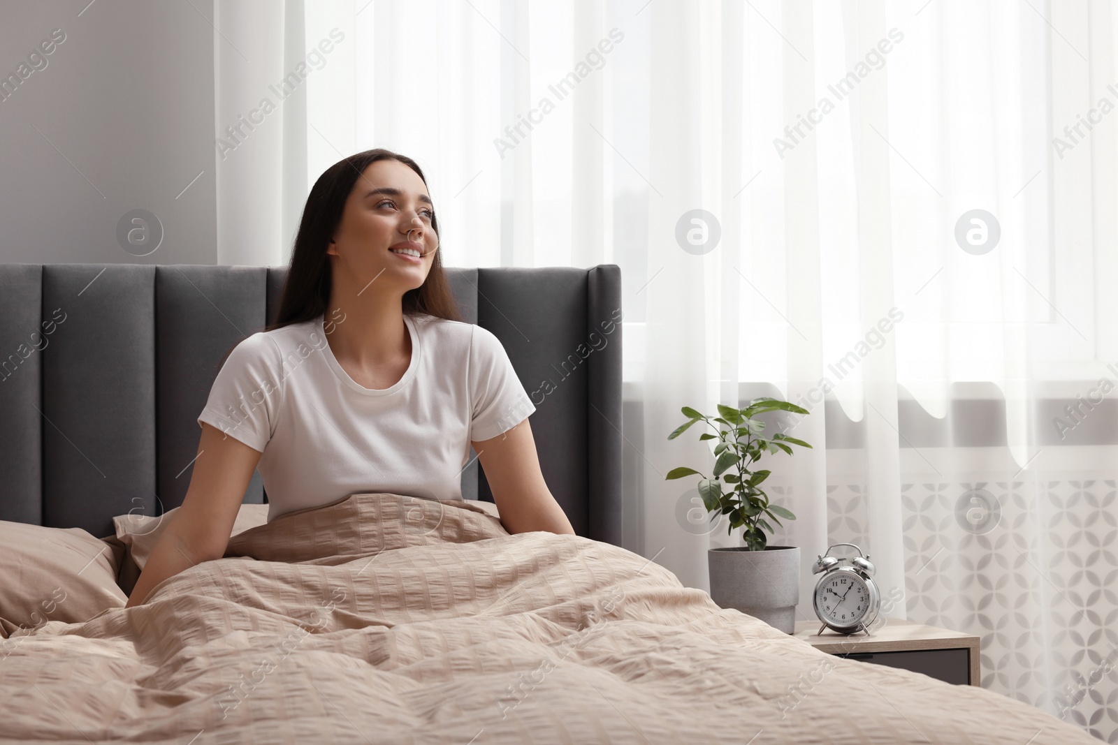 Photo of Beautiful woman in bed at home. Lazy morning