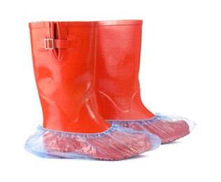 Photo of Rubber boots in blue shoe covers isolated on white