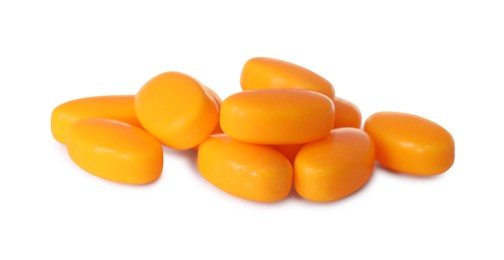 Tasty orange dragee candies on white background
