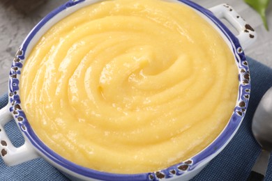 Photo of Delicious lemon curd in bowl on table, closeup
