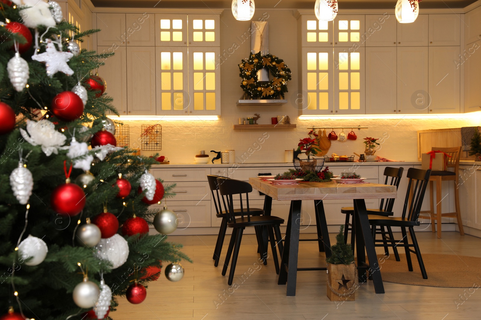 Photo of Cozy dining room interior with Christmas tree and beautiful festive decor