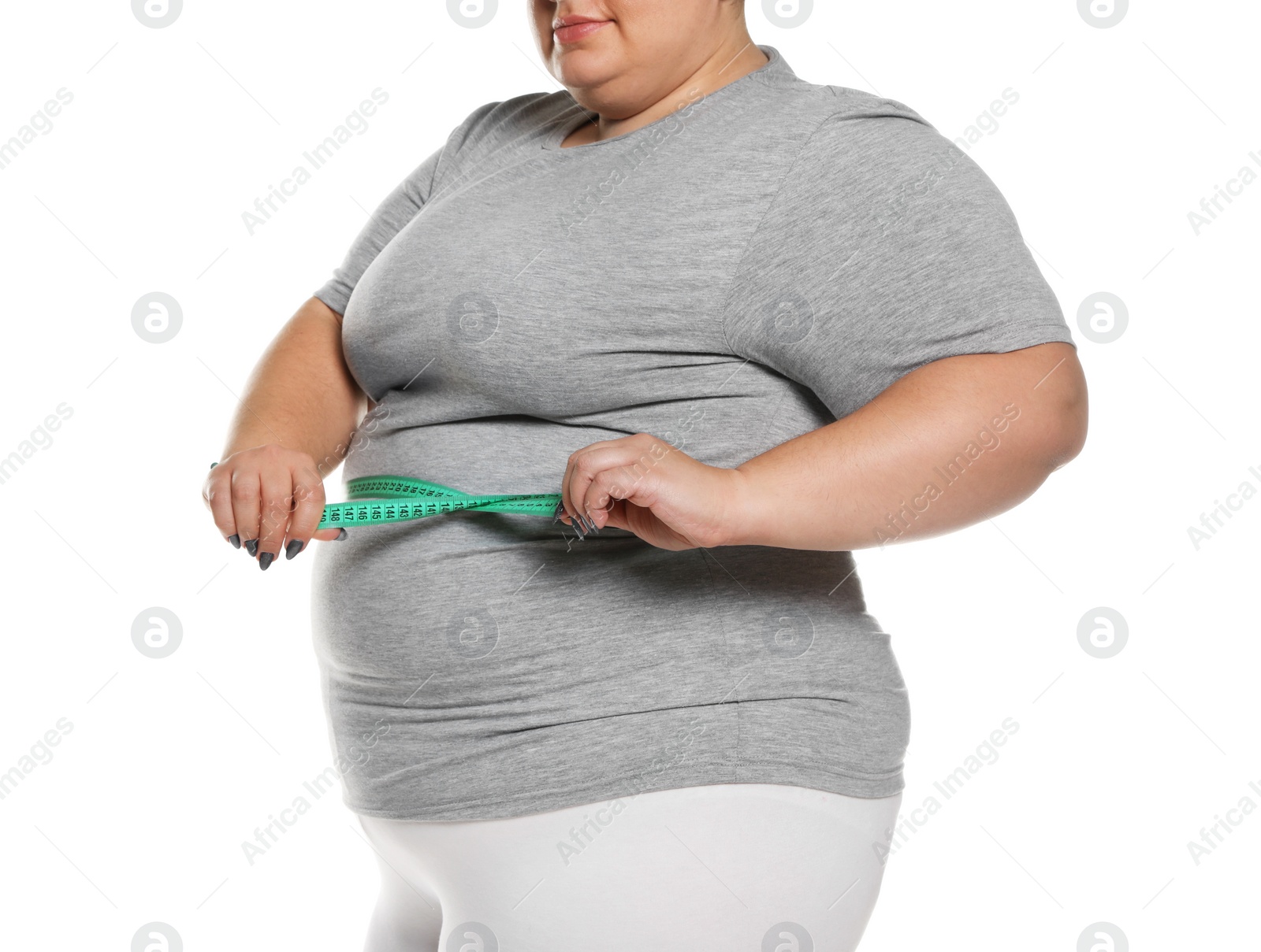 Photo of Overweight woman measuring waist with tape on white background, closeup