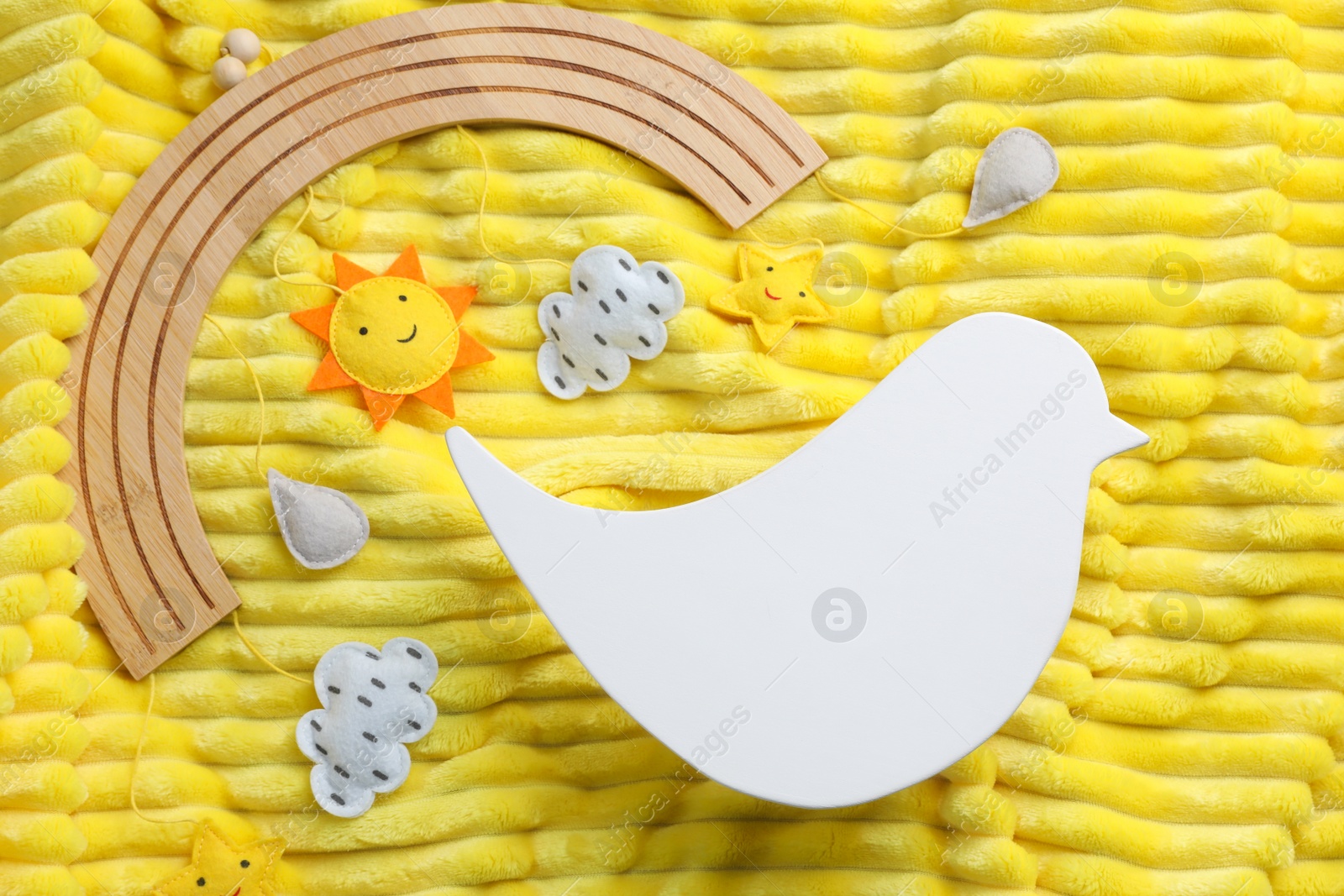 Photo of Flat lay composition with bird shaped child's night lamp on yellow fabric