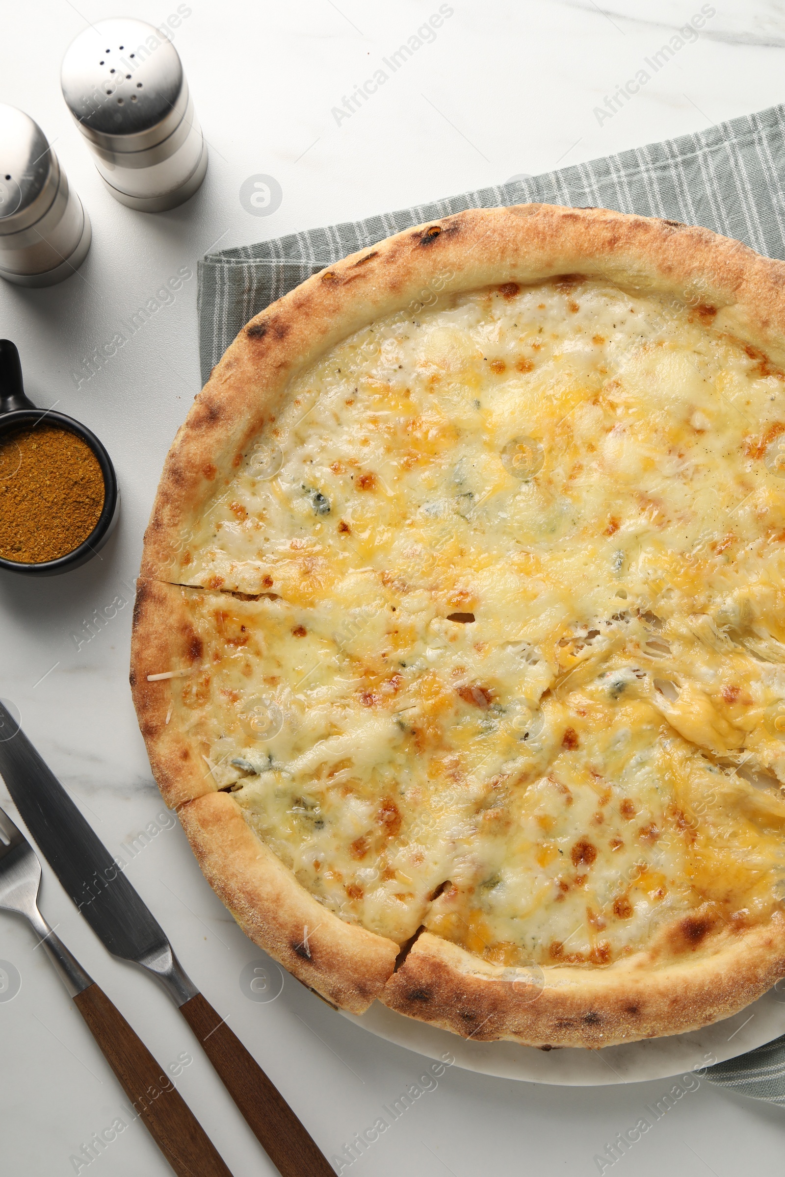 Photo of Delicious cheese pizza served on white marble table, flat lay