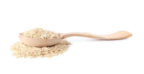 Spoon and uncooked brown rice on white background