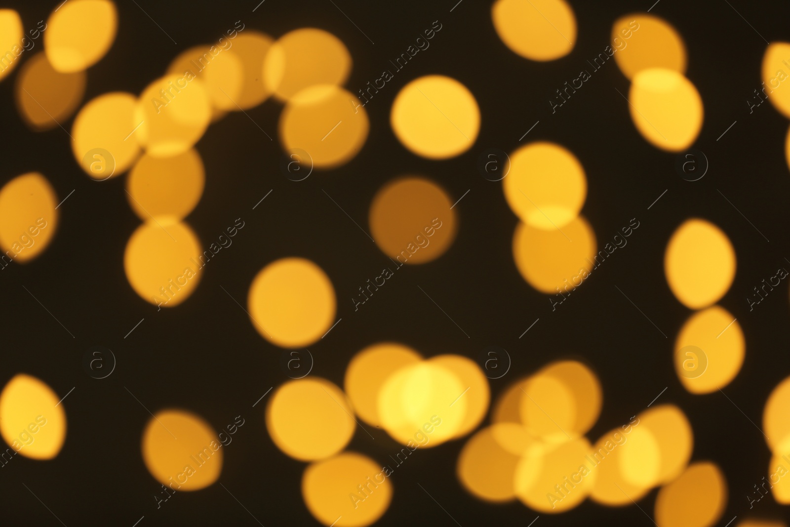 Photo of Beautiful golden lights on dark background. Bokeh effect