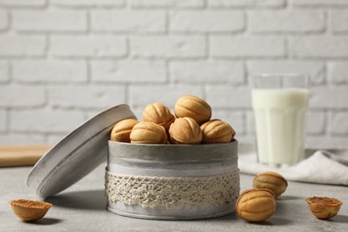 Photo of Delicious nut shaped cookies with boiled condensed milk on light grey table