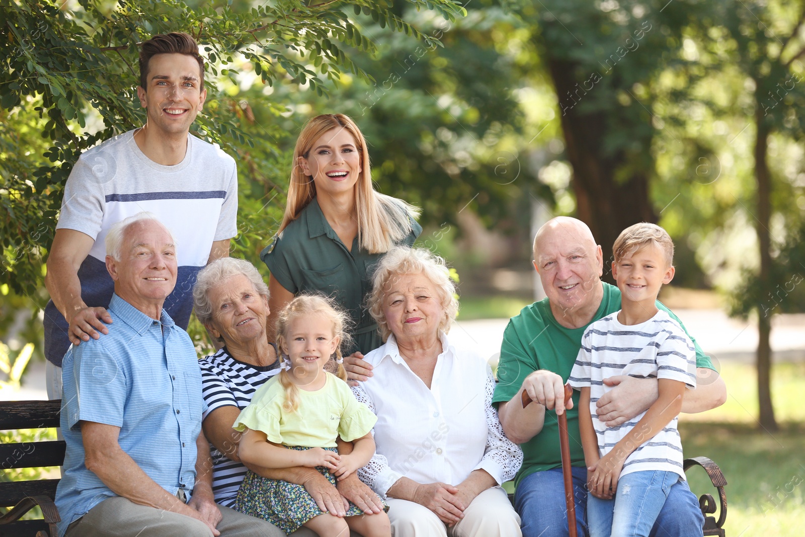 Photo of Couple with children and elderly parents in park