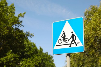 Road sign Pedestrian and Bicycle Crossings outdoors on sunny day. Space for text
