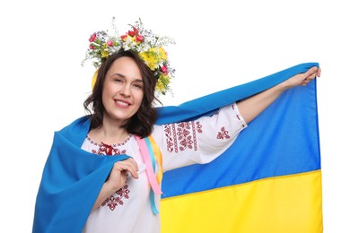 Photo of Happy woman in national clothes with flag of Ukraine on white background