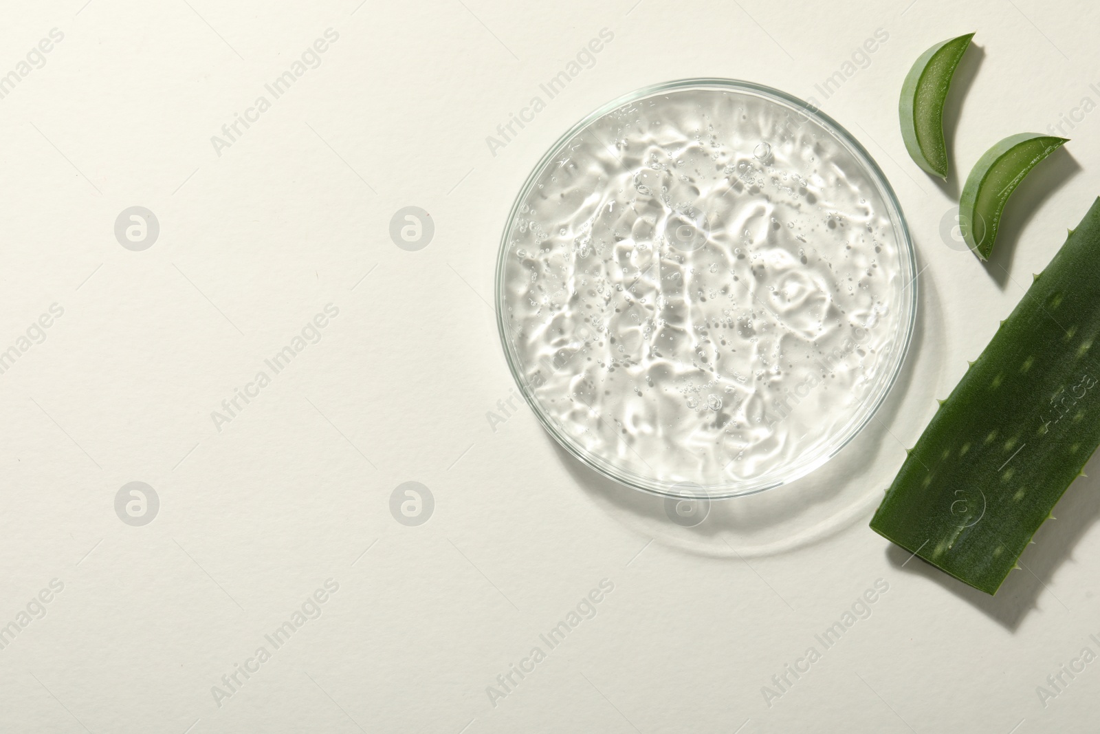 Photo of Cosmetic gel and aloe on white background, flat lay. Space for text