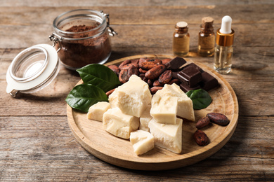 Photo of Composition with organic cocoa butter on wooden table