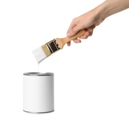 Photo of Woman holding brush over paint can on white background. Space for design