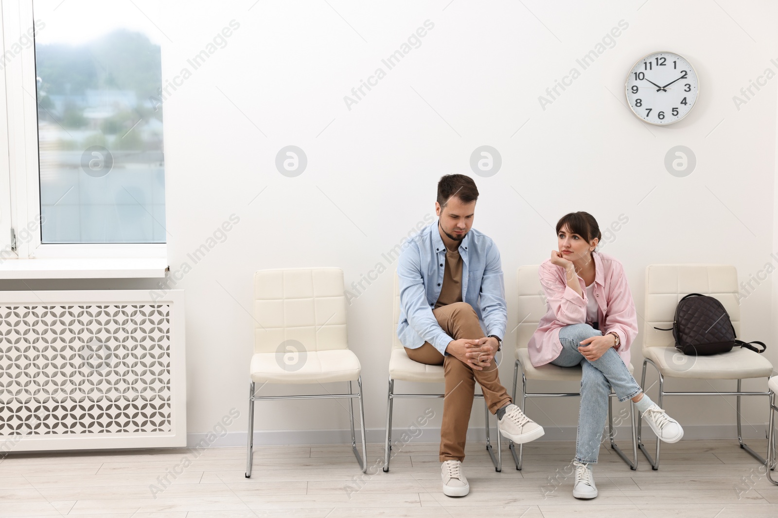 Photo of Man and woman waiting for appointment indoors