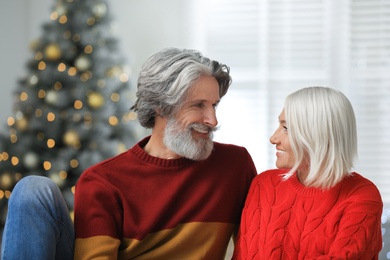 Photo of Happy mature couple celebrating Christmas at home