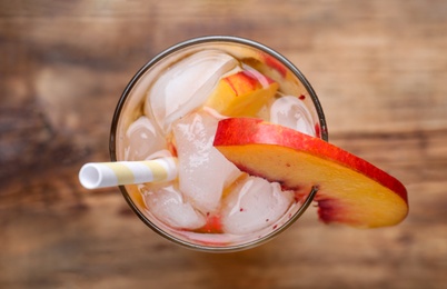 Photo of Delicious peach lemonade made with soda water on table, top view