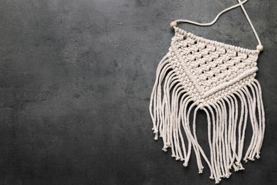 Photo of Stylish beige macrame on grey table, top view. Space for text