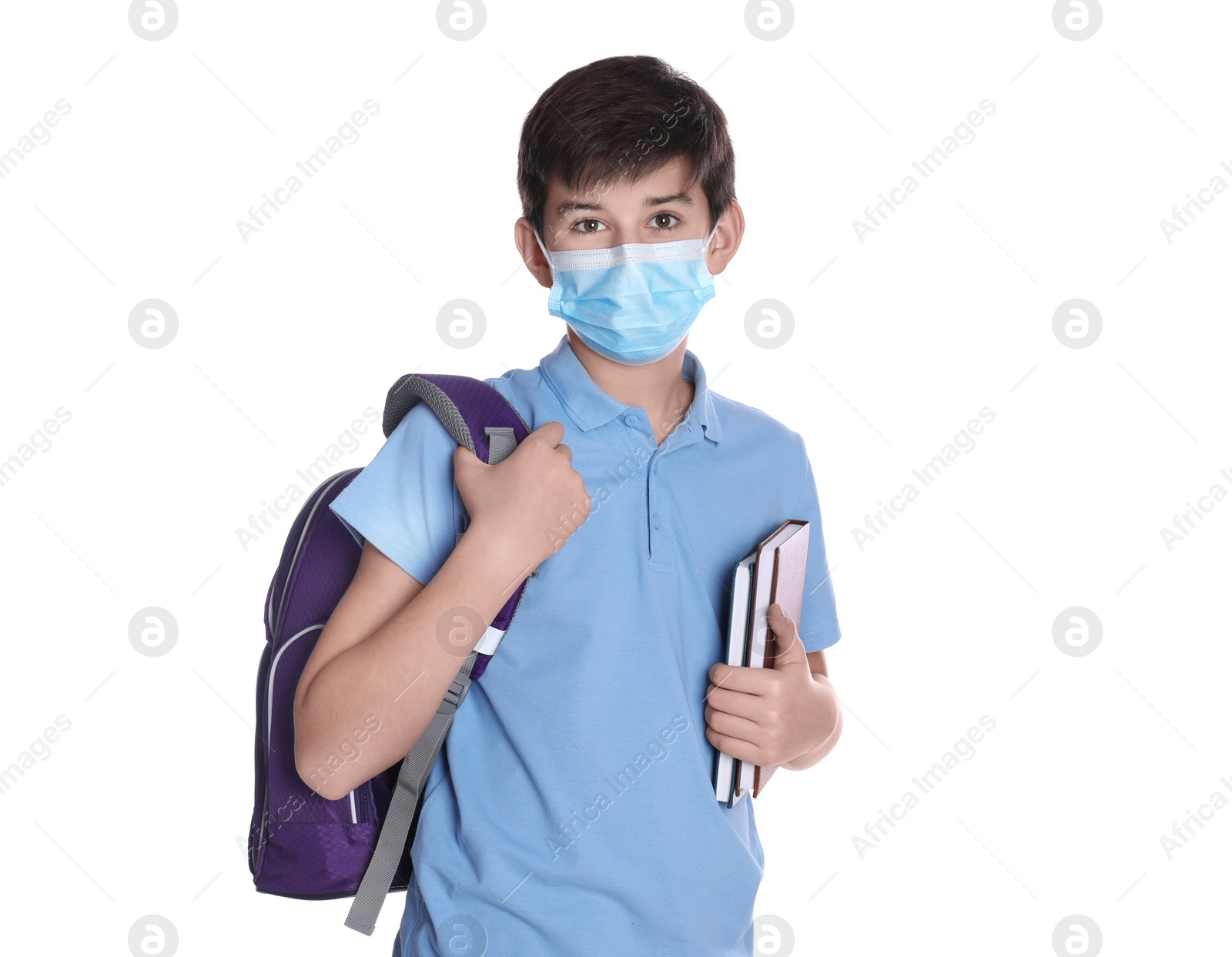 Photo of Boy wearing protective mask with backpack and books on white background. Child safety