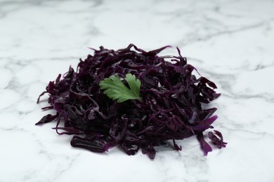 Photo of Tasty red cabbage sauerkraut with parsley on white marble table