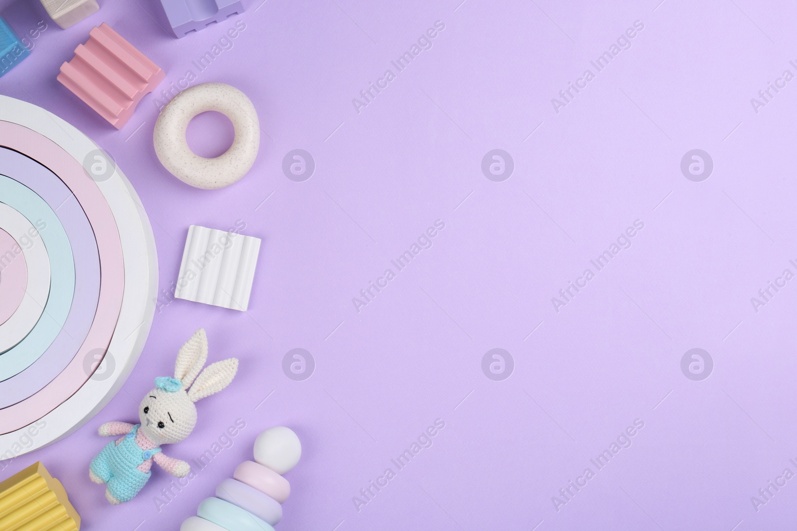 Photo of Different children's toys on violet background, flat lay. Space for text