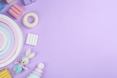 Different children's toys on violet background, flat lay. Space for text