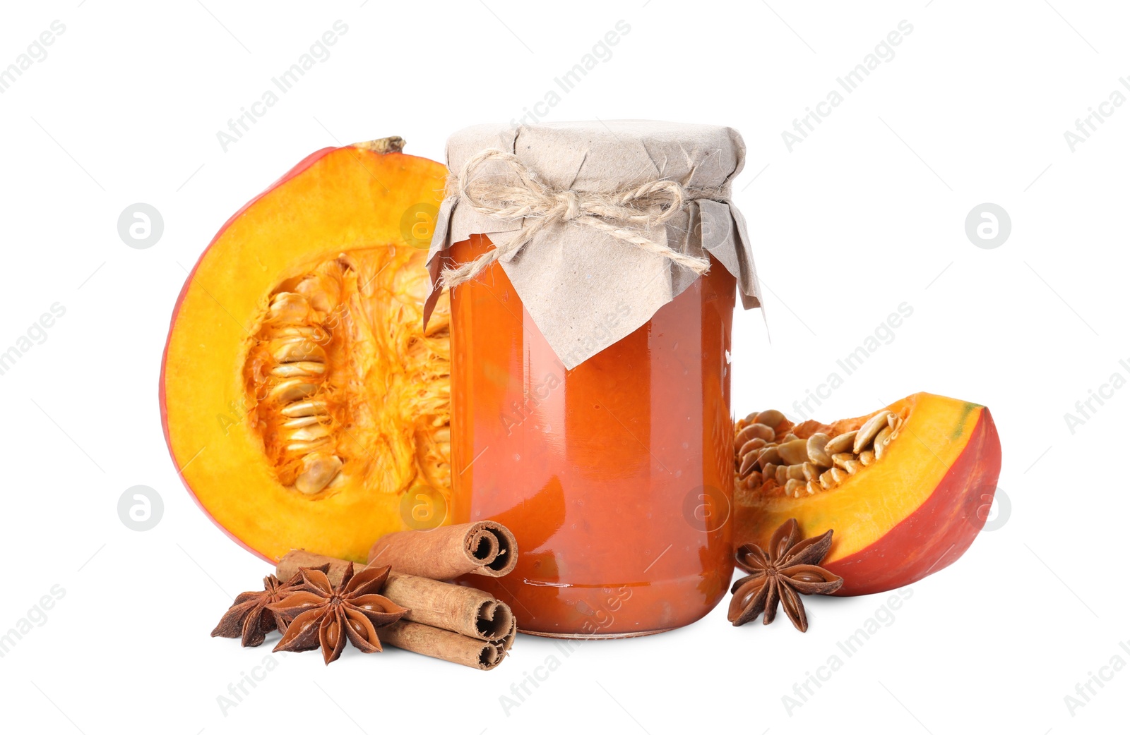 Photo of Jar of pumpkin jam, star anise, fresh pumpkin and cinnamon on white background