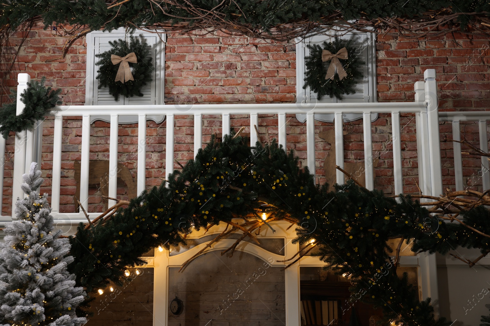 Photo of Stylish garlands and other Christmas decor indoors. Interior design