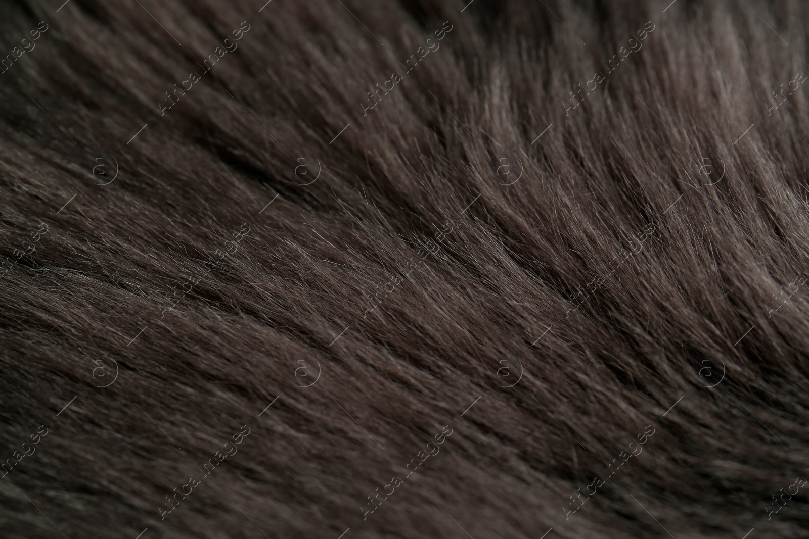 Photo of Beautiful dark faux fur as background, closeup view