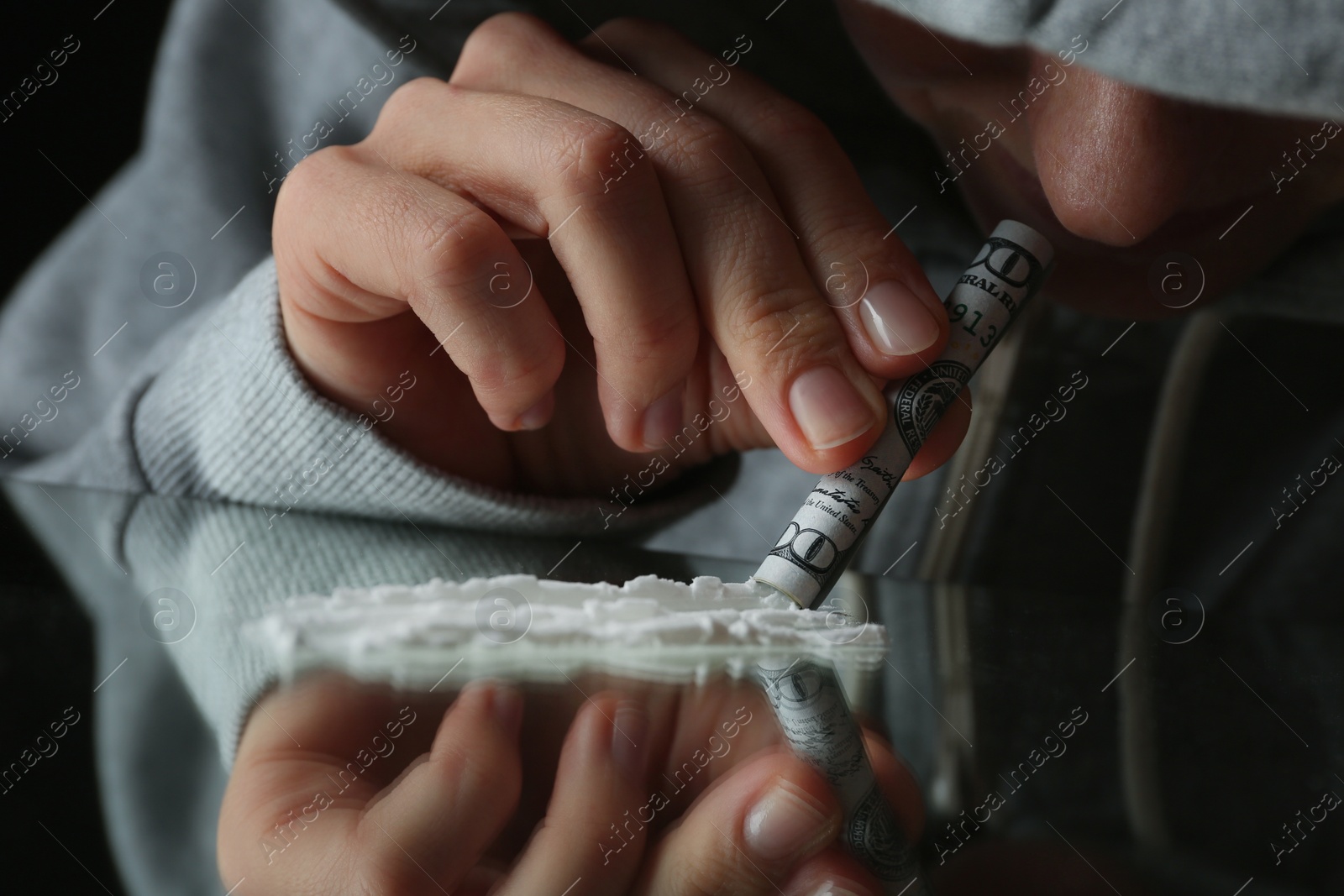 Photo of Drug addict taking cocaine at table, closeup view