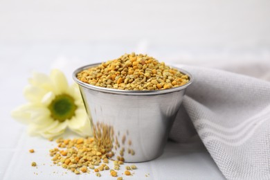 Photo of Fresh bee pollen granules on white table, closeup