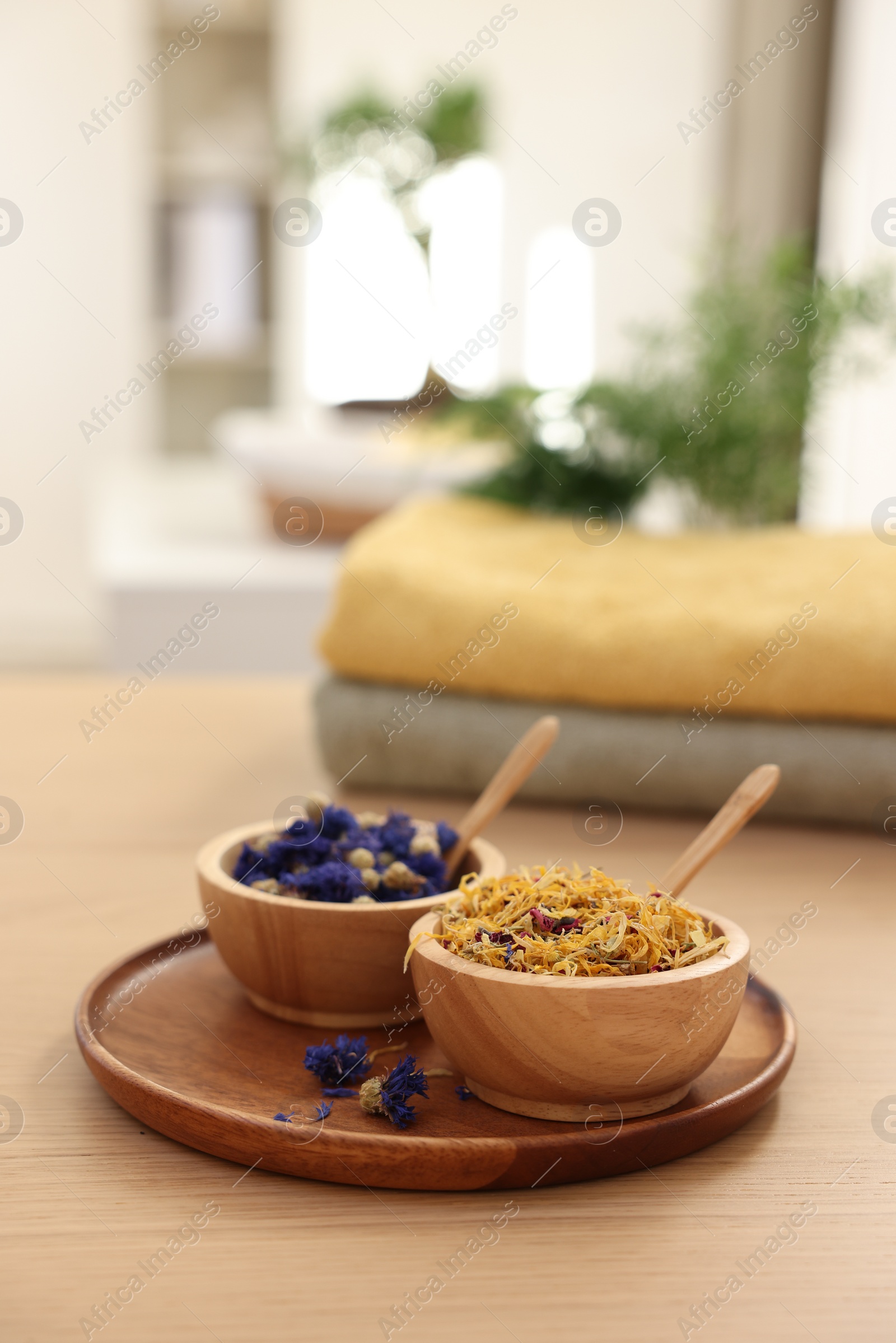 Photo of Dry flowers on wooden table indoors, space for text. Spa time