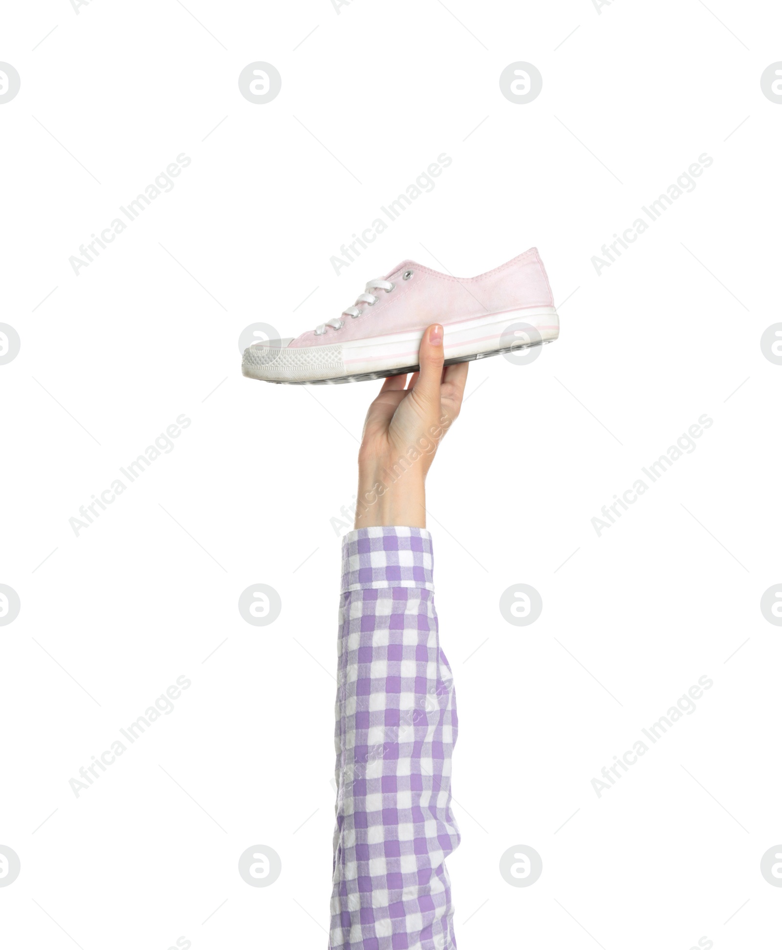 Photo of Young woman holding comfortable shoe on white background, closeup