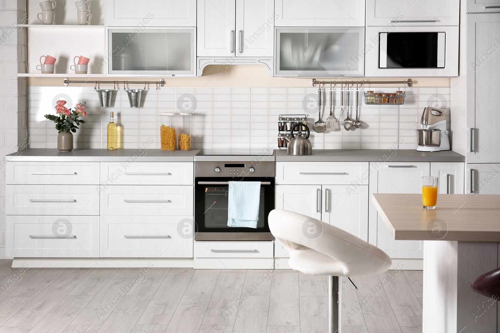 Photo of Light modern kitchen interior with new oven