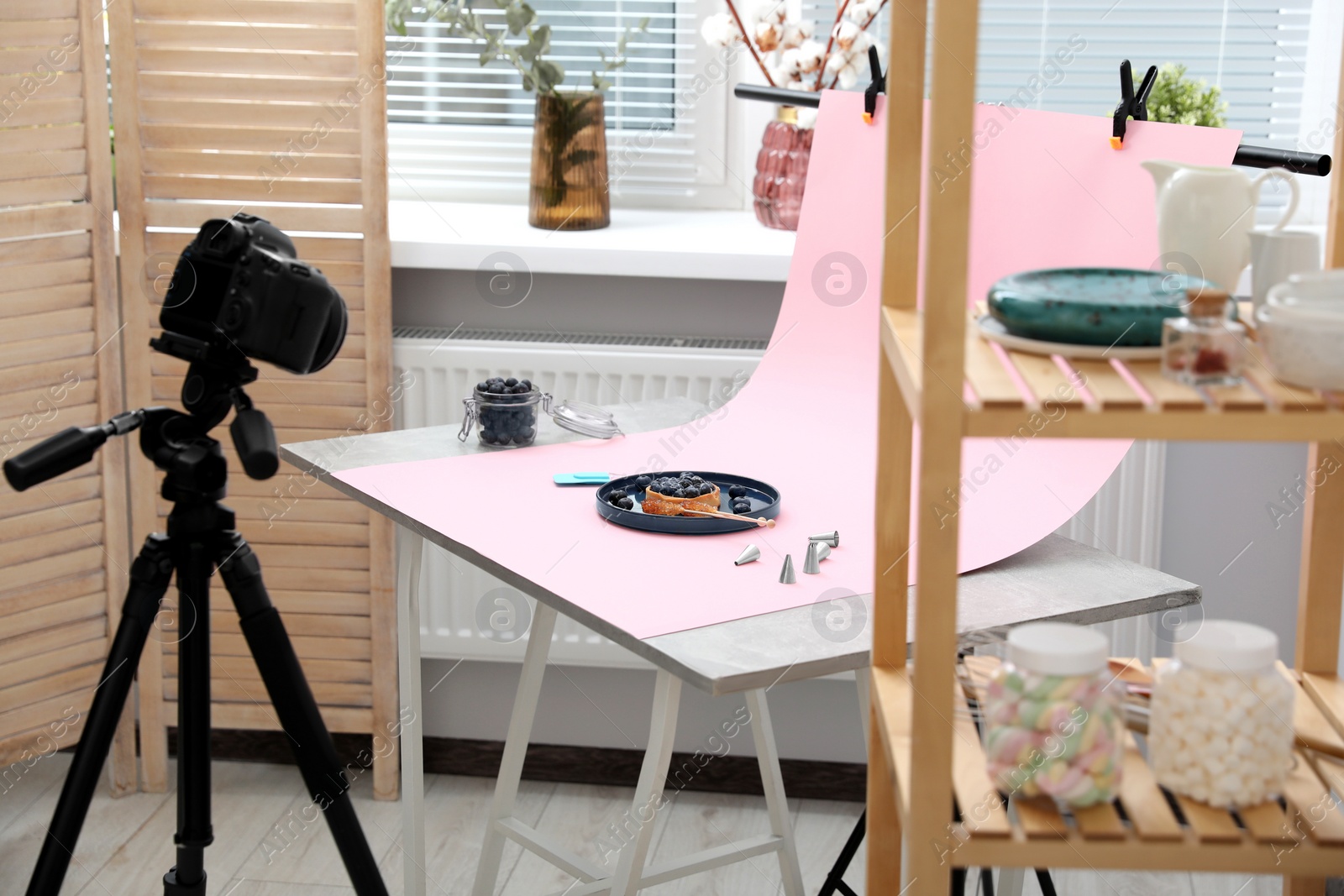 Photo of Professional equipment and composition with delicious dessert on pink background in studio. Food photography