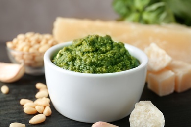 Photo of Bowl of pesto sauce and ingredients on table