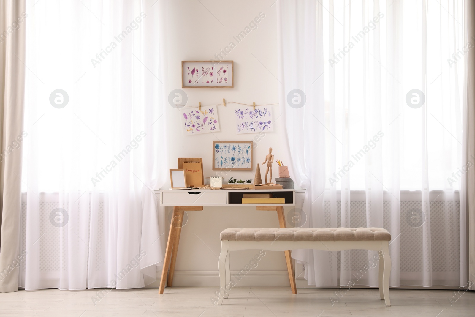 Photo of Stylish room interior with creative workplace near white wall